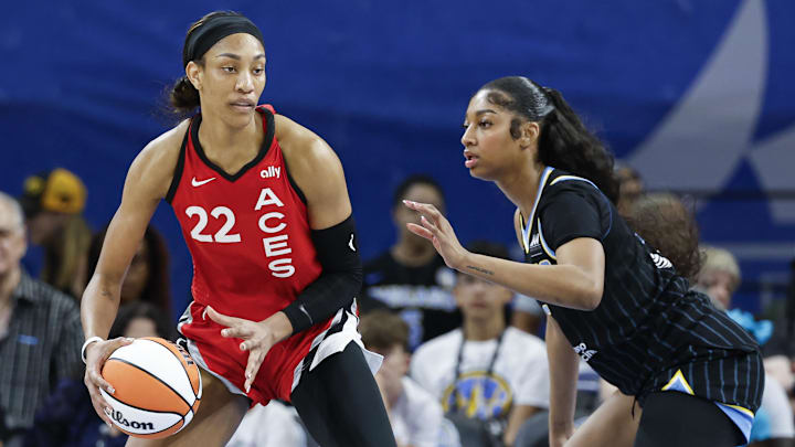 Aug 25, 2024; Chicago, Illinois, USA; Las Vegas Aces center A'ja Wilson (22) is defended by Chicago Sky forward Angel Reese (5) during the first half at Wintrust Arena. Mandatory Credit: Kamil Krzaczynski-Imagn Images