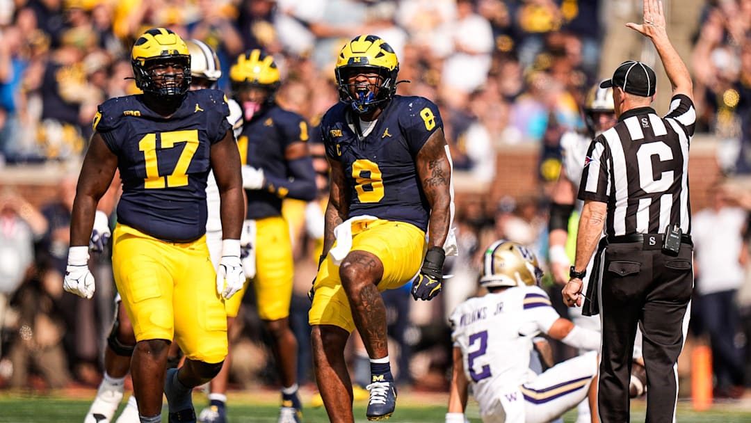 Michigan edge Derrick Moore (8) celebrates a sack against Washington quarterback Demond Williams Jr. (2) during the first half at Michigan Stadium in Ann Arbor on Saturday, Oct. 18, 2025.