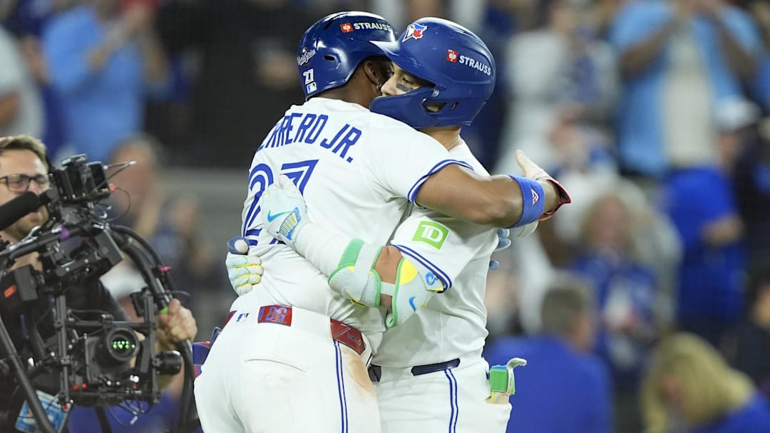 Nov 1, 2025; Toronto, Ontario, CAN; Toronto Blue Jays designated hitter Bo Bichette (11) celebrates with first baseman Vladimir Guerrero Jr. (27) after hitting a three run home run against the Los Angeles Dodgers in the third inning during game seven of the 2025 MLB World Series at Rogers Centre. Mandatory Credit: John E. Sokolowski-Imagn Images