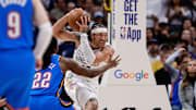 Denver Nuggets forward Gordon controls the ball under pressure from Oklahoma City Thunder guard Wallace in the fourth quarter during game six of the second round for the 2025 NBA Playoffs at Ball Arena. 