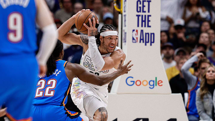 Denver Nuggets forward Gordon controls the ball under pressure from Oklahoma City Thunder guard Wallace in the fourth quarter during game six of the second round for the 2025 NBA Playoffs at Ball Arena. 