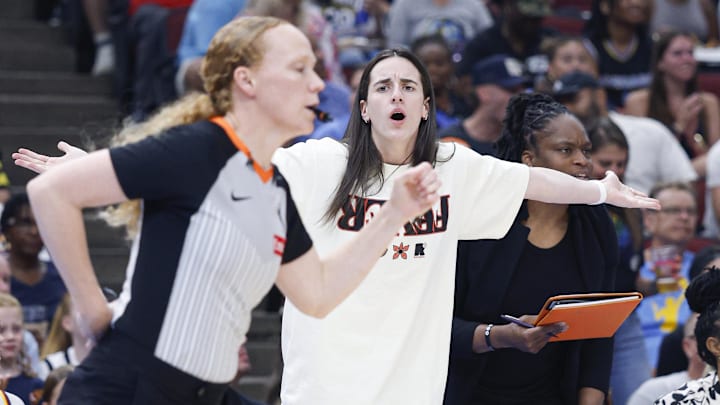 Jul 27, 2025; Chicago, Illinois, USA; Injured Indiana Fever guard Caitlin Clark (22) reacts to a call against her team during the first half of a basketball game against the Chicago Sky at United Center. Mandatory Credit: Kamil Krzaczynski-Imagn Images