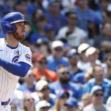 Jun 2, 2024; Chicago, Illinois, USA; Chicago Cubs outfielder Cody Bellinger (24) hits an RBI single against the Cincinnati Reds during the fifth inning at Wrigley Field.