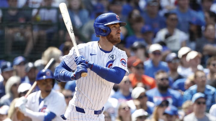 Jun 2, 2024; Chicago, Illinois, USA; Chicago Cubs outfielder Cody Bellinger (24) hits an RBI single against the Cincinnati Reds during the fifth inning at Wrigley Field