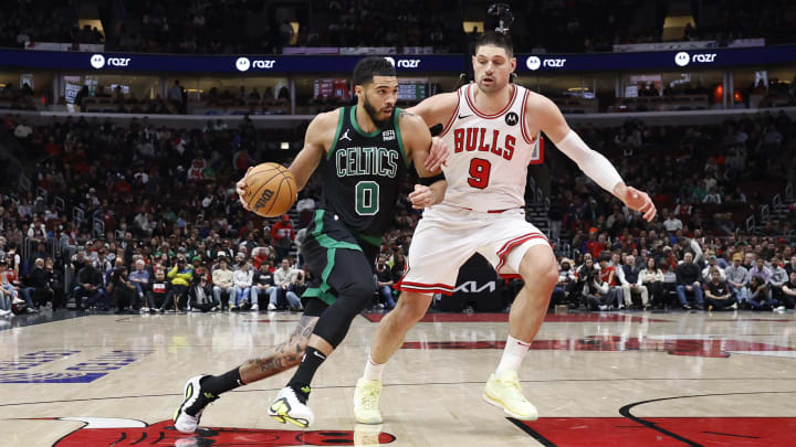 Feb 22, 2024; Chicago, Illinois, USA; Boston Celtics forward Jayson Tatum (0) drives to the basket against Chicago Bulls center Nikola Vucevic (9) during the second half at United Center. Mandatory Credit: Kamil Krzaczynski-USA TODAY Sports