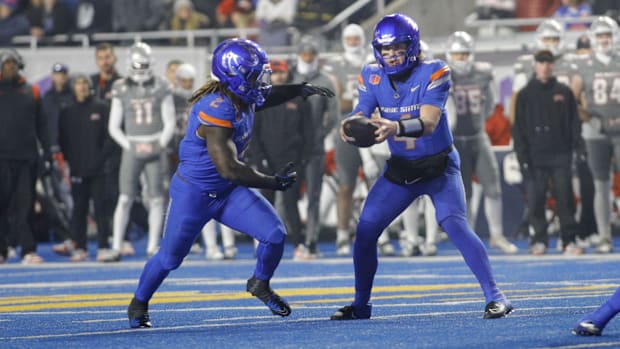 Boise State Broncos quarterback Maddux Madsen hands off to running back Ashton Jeanty.