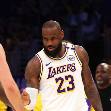 Los Angeles Lakers guard Luka Doncic and forward LeBron James talk in between play.