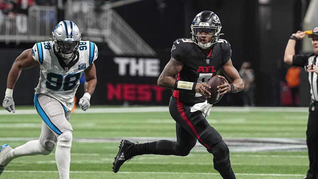 Jan 5, 2025; Atlanta, Georgia, USA; Atlanta Falcons quarterback Michael Penix Jr. (9) runs against the Carolina Panthers during the second half at Mercedes-Benz Stadium. Mandatory Credit: Dale Zanine-Imagn Images