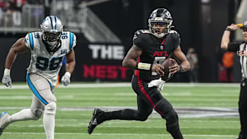 Jan 5, 2025; Atlanta, Georgia, USA; Atlanta Falcons quarterback Michael Penix Jr. (9) runs against the Carolina Panthers during the second half at Mercedes-Benz Stadium. Mandatory Credit: Dale Zanine-Imagn Images