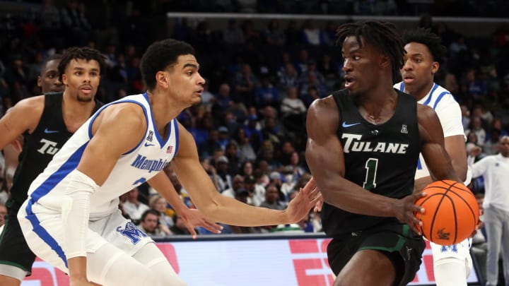 Feb 11, 2024; Memphis, Tennessee, USA; Tulane Green Wave guard Sion James (1) drives to the basket as Memphis Tigers forward Nicholas Jourdain (2) defends during the second half at FedExForum. Mandatory Credit: Petre Thomas-USA TODAY Sports