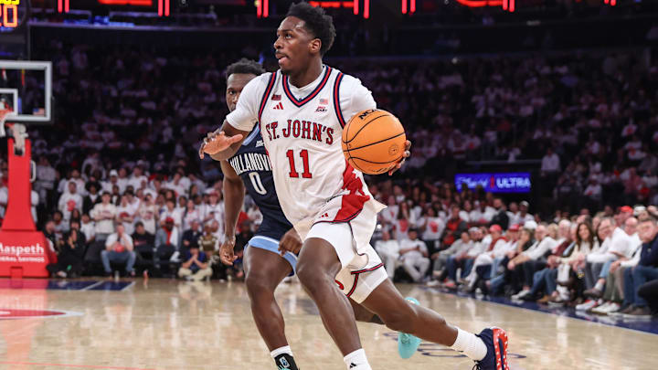 Feb 28, 2026; New York, New York, USA;  St. John's basketball guard Ian Jackson (11) drives past Villanova Wildcats guard Christian Jeffrey (0) in the second half at Madison Square Garden.