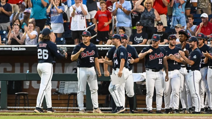 Jun 20, 2022; Omaha, NE, USA;  Ole Miss Rebels pitcher Hunter Elliott (26) greets teammates after being taken out against the Arkansas Razorbacks in the seventh inning at Charles Schwab Field. Mandatory Credit: Steven Branscombe-USA TODAY Sports