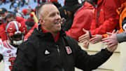 Nov 24, 2018; Chapel Hill, NC, USA; North Carolina State Wolfpack head coach Dave Doeren (left) greets fans after a win against the North Carolina Tar Heels at Kenan Memorial Stadium. The Wolfpack won 34-28 in overtime. Mandatory Credit: Rob Kinnan-Imagn Images