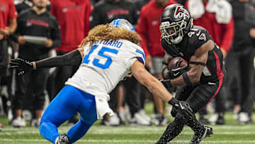 Aug 8, 2025; Atlanta, Georgia, USA; Atlanta Falcons running back Elijah Dotson (41) runs against Detroit Lions linebacker Grant Stuard (15) during the first quarter at Mercedes-Benz Stadium. Mandatory Credit: Dale Zanine-Imagn Images