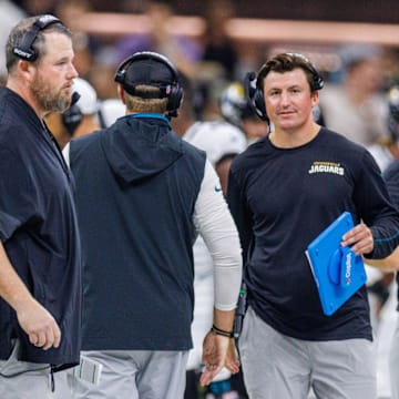 Aug 17, 2025; New Orleans, Louisiana, USA;  Jacksonville Jaguars offensive coordinator Grant Udinski  (blue binder) reacts to a touchdown against the New Orleans Saints during the first half at Caesars Superdome. Mandatory Credit: Stephen Lew-Imagn Images