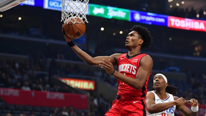 Apr 14, 2024; Los Angeles, California, USA;  Houston Rockets forward Amen Thompson (1) shoots ahead of Los Angeles Clippers guard Terance Mann (14) during the first half at Crypto.com Arena. Mandatory Credit: Gary A. Vasquez-USA TODAY Sports