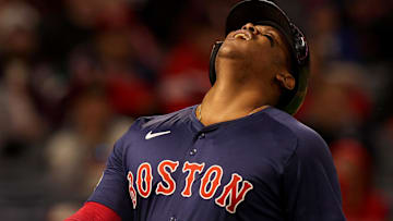 Boston Red Sox third baseman Rafael Devers (11) reacts after being hit by a pitch during the sixth inning against the Los Angeles Angels at Angel Stadium.