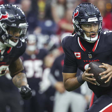 Dec 15, 2024; Houston, Texas, USA; Houston Texans quarterback C.J. Stroud (7) rolls out on a play during the game against the Miami Dolphins at NRG Stadium. Mandatory Credit: Troy Taormina-Imagn Images