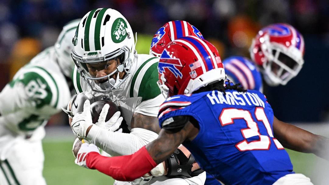 Jan 4, 2026; Orchard Park, New York, USA; New York Jets wide receiver John Metchie III (3) carries the ball defended by Buffalo Bills cornerback Maxwell Hairston (31) during the fourth quarter at Highmark Stadium.