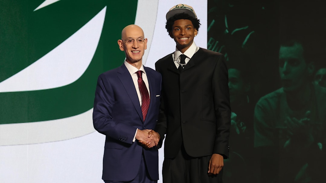 AJ Johnson poses for photos with NBA commissioner Adam Silver after being selected in the first round by the Milwaukee Bucs in the 2024 NBA Draft at Barclays Center. 