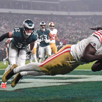 Dec 3, 2023; Philadelphia, Pennsylvania, USA; San Francisco 49ers wide receiver Brandon Aiyuk (11) catches touchdown pass against Philadelphia Eagles safety Reed Blankenship (32) during the second quarter at Lincoln Financial Field. Mandatory Credit: Eric Hartline-USA TODAY Sports