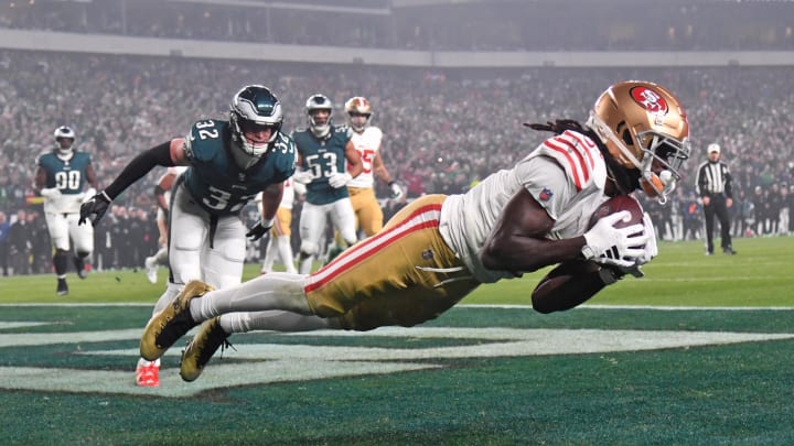 Dec 3, 2023; Philadelphia, Pennsylvania, USA; San Francisco 49ers wide receiver Brandon Aiyuk (11) catches touchdown pass against Philadelphia Eagles safety Reed Blankenship (32) during the second quarter at Lincoln Financial Field. Mandatory Credit: Eric Hartline-USA TODAY Sports