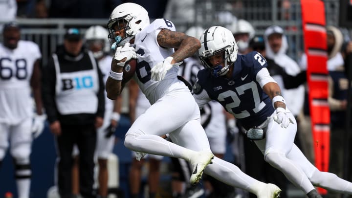 Penn State Nittany Lions wide receiver Harrison Wallace III (6) runs with the ball while trying to avoid a tackle from safety Lamont Payne Jr. during the Blue-White Game. 