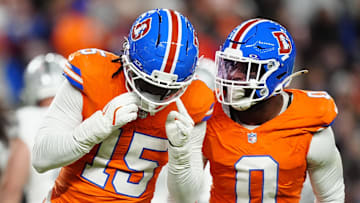 Nov 6, 2025; Denver, Colorado, USA; Denver Broncos linebacker Nik Bonitto (15) and linebacker Jonathon Cooper (0) react during the first half at Empower Field at Mile High. Mandatory Credit: Ron Chenoy-Imagn Images