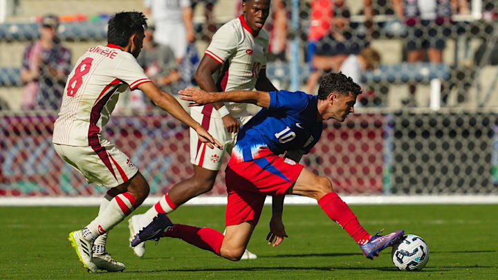 Sep 7, 2024; Kansas City, Kansas, USA; United States forward Christian Pulisic (10) controls the ball against Canada midfielder Mathieu Choiniere (8) and forward Jonathan David (10) during the second half at Children’s Mercy Park. Sep 7, 2024; Kansas City, Kansas, USA; United States forward Christian Pulisic (10) controls the ball against Canada midfielder Mathieu Choiniere (8) and forward Jonathan David (10) during the second half at Children’s Mercy Park.