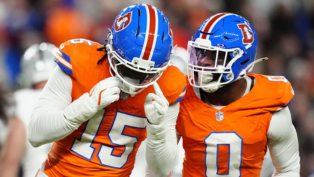Nov 6, 2025; Denver, Colorado, USA; Denver Broncos linebacker Nik Bonitto (15) and linebacker Jonathon Cooper (0) react during the first half at Empower Field at Mile High. 