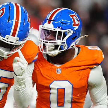 Nov 6, 2025; Denver, Colorado, USA; Denver Broncos linebacker Nik Bonitto (15) and linebacker Jonathon Cooper (0) react during the first half at Empower Field at Mile High. 