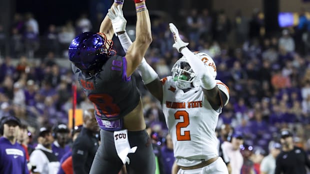The wide receiver of TCU horns, Jack Bech, takes a jump on Oklahoma State Cowboys DB. 