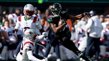 Oct 30, 2022; East Rutherford, New Jersey, USA; New York Jets wide receiver Garrett Wilson (17) runs with the ball against New England Patriots cornerback Jalen Mills (2) and safety Devin McCourty (32) during the first quarter at MetLife Stadium. Mandatory Credit: Brad Penner-USA TODAY Sports