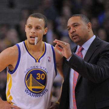 January 11, 2013; Oakland, CA, USA; Golden State Warriors head coach Mark Jackson (right) instructs point guard Stephen Curry (30) during the second quarter against the Portland Trail Blazers at Oracle Arena. Mandatory Credit: Kyle Terada-USA TODAY Sports