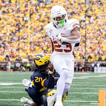 Texas running back Jaydon Blue (23) runs into the end zone for a touchdown against Michigan defensive back Jyaire Hill (20) during the second half at Michigan Stadium in Ann Arbor on Saturday, September 7, 2024.