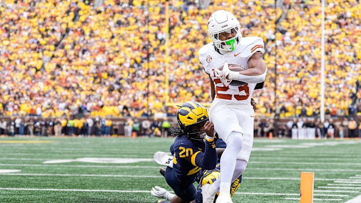 Texas running back Jaydon Blue (23) runs into the end zone for a touchdown against Michigan defensive back Jyaire Hill (20) during the second half at Michigan Stadium in Ann Arbor on Saturday, September 7, 2024.