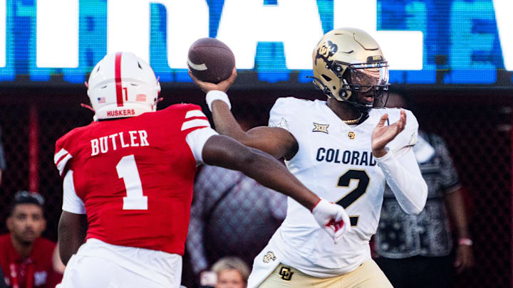 Sep 7, 2024; Lincoln, Nebraska, USA; Colorado Buffaloes quarterback Shedeur Sanders (2) passes against Nebraska Cornhuskers defensive lineman Jimari Butler (1) during the first quarter at Memorial Stadium.