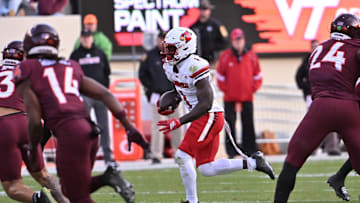 Nov 1, 2025; Blacksburg, Virginia, USA;  Louisville Cardinals running back Isaac Brown (1) runs the ball against the Virginia Tech Hokies defense during the third quarter at Lane Stadium. Mandatory Credit: Brian Bishop-Imagn Images