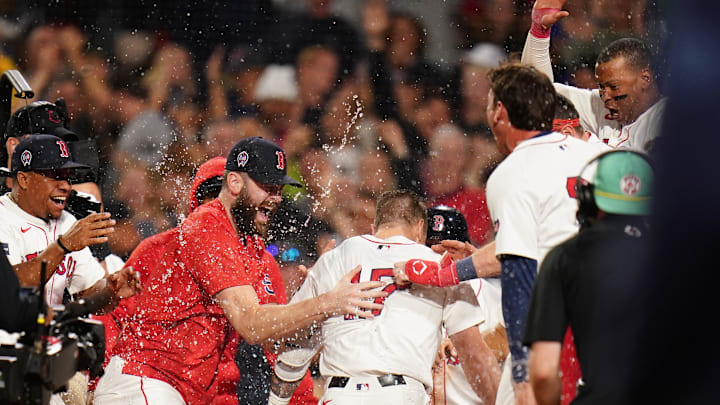 Sep 11, 2024; Boston, Massachusetts, USA; Boston Red Sox left fielder Tyler O'Neill (17) his a three run home run to win the game against the Baltimore Orioles in ten innings at Fenway Park. Mandatory Credit: David Butler II-Imagn Images