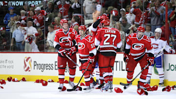 April 8, 2010; Raleigh, NC, USA; Carolina Hurricanes center Eric Staal (far left) is congratulated by teammates after his hat trick goal during the 3rd period against the Montreal Canadiens at the RBC center. The Hurricanes defeated the Canadiens 5-2. Mandatory Credit: James Guillory-Imagn Images
