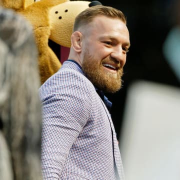Sep 21, 2021; Chicago, Illinois, USA; MMA fighter Conor McGregor smiles as he walks on the field before the game between the Chicago Cubs and the Minnesota Twins at Wrigley Field.
