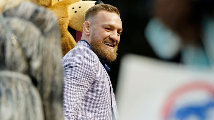 Sep 21, 2021; Chicago, Illinois, USA; MMA fighter Conor McGregor smiles as he walks on the field before the game between the Chicago Cubs and the Minnesota Twins at Wrigley Field.
