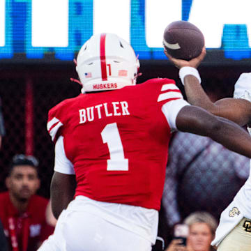 Sep 7, 2024; Lincoln, Nebraska, USA; Colorado Buffaloes quarterback Shedeur Sanders (2) passes against Nebraska Cornhuskers defensive lineman Jimari Butler (1) during the first quarter at Memorial Stadium.