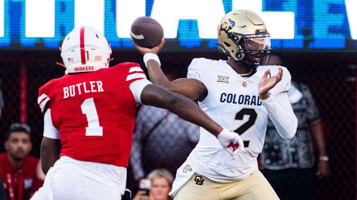 Sep 7, 2024; Lincoln, Nebraska, USA; Colorado Buffaloes quarterback Shedeur Sanders (2) passes against Nebraska Cornhuskers defensive lineman Jimari Butler (1) during the first quarter at Memorial Stadium.