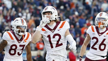 Nov 25, 2023; Charlottesville, Virginia, USA; Virginia Tech Hokies wide receiver Stephen Gosnell (12) celebrates after scoring a touchdown against the Virginia Cavaliers during the first quarter at Scott Stadium. Mandatory Credit: Geoff Burke-Imagn Images