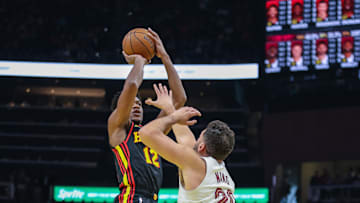 Nov 29, 2024; Atlanta, Georgia, USA; Cleveland Cavaliers forward Georges Niang (20) attempts to block shot against Atlanta Hawks forward De'Andre Hunter (12) during the first quarter at State Farm Arena. Mandatory Credit: Jordan Godfree-Imagn Images