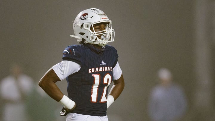 Chaminade-Madonna's Zaquan Patterson (12) walks off the field to meet with his team during a