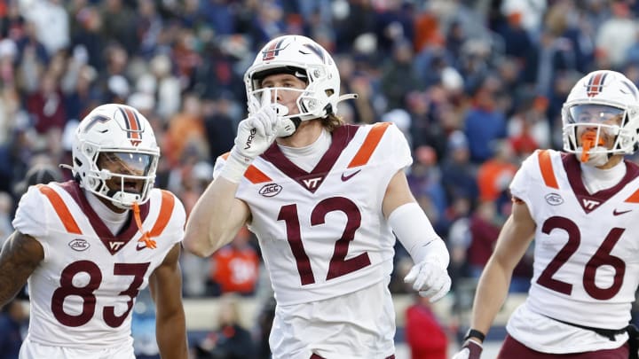 Nov 25, 2023; Charlottesville, Virginia, USA; Virginia Tech Hokies wide receiver Stephen Gosnell (12) celebrates after scoring a touchdown against the Virginia Cavaliers during the first quarter at Scott Stadium. Mandatory Credit: Geoff Burke-USA TODAY Sports