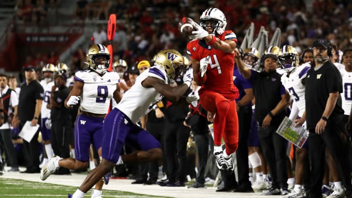 Sep 30, 2023; Tucson, Arizona, USA; Arizona Wildcats wide receiver Tetairoa McMillan (4) gets hit by Washington Huskies cornerback Dominique Hampton (7) while attempting to catch a pass in the second half at Arizona Stadium. 