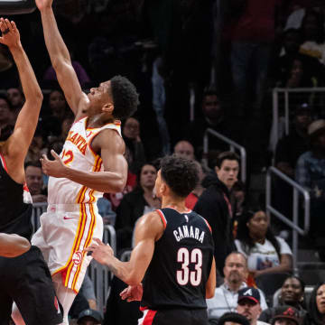 Mar 27, 2024; Atlanta, Georgia, USA; Atlanta Hawks guard Dejounte Murray (5) shoots layup shot against Portland Trail Blazers forward Kris Murray (8), Portland Trail Blazers guard Shaedon Sharpe (19), and Portland Trail Blazers forward Toumani Camara (33) during the second quarter at State Farm Arena. Mandatory Credit: Jordan Godfree-USA TODAY Sports